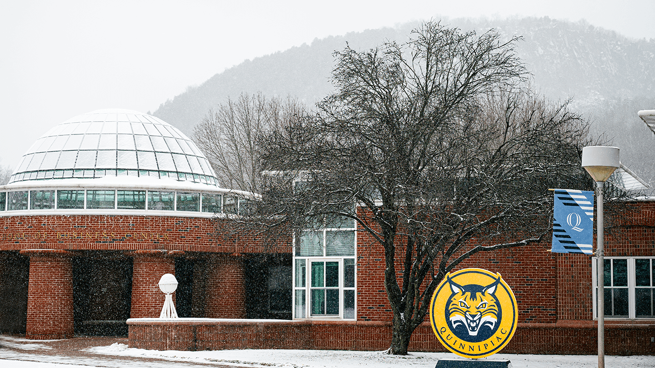 The dome on the School of Business on Quinnipiac's Mount Carmel Campus is covered in snow.