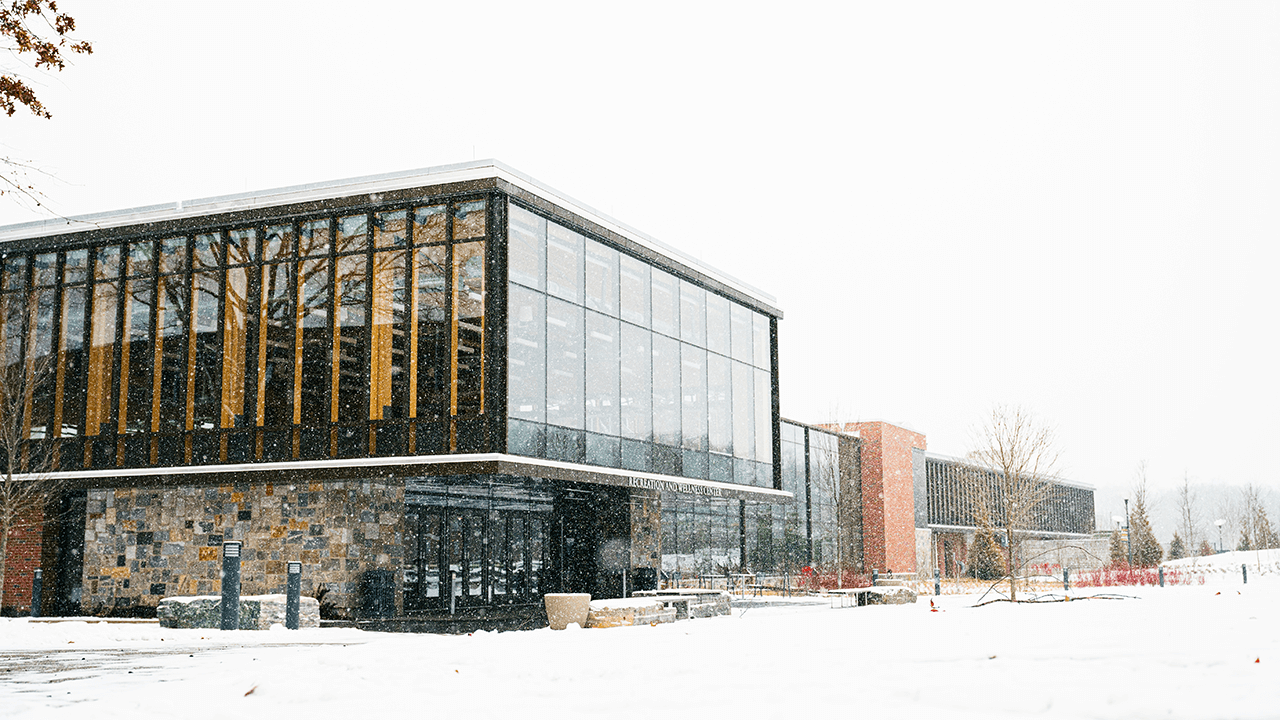 Snow flurries in front of Quinnipiac's Rec and Wellness center on the Mount Carmel Campus