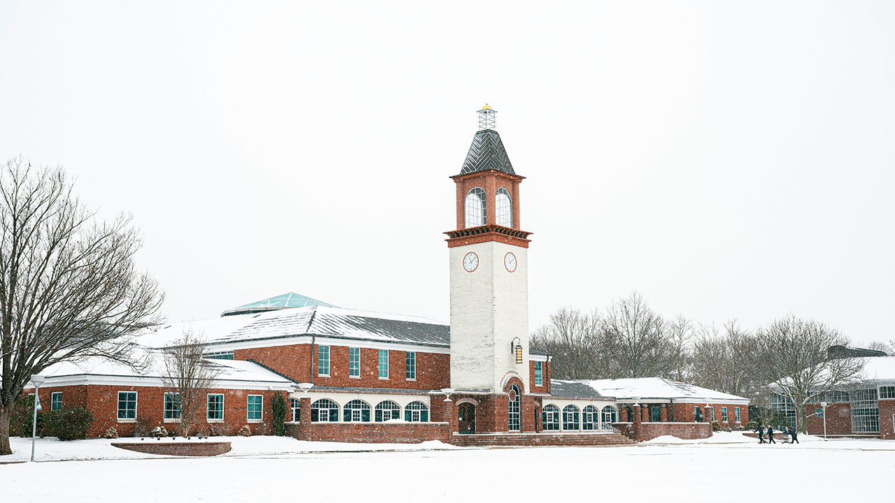 The Arnold Bernhard Library is covered in a blanket of snow.