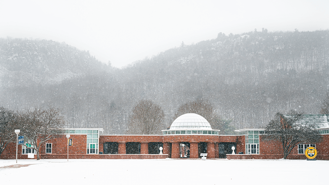 Snow flutters along the School of Business as it is against Sleeping Giant