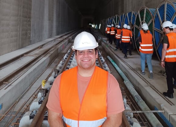 Steven Gomes stands on train tracks