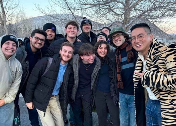 Students pose for a photo with American actor and comedian, Bowen Yang.