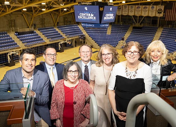 Award recipients smile as a group during the ceremony reception