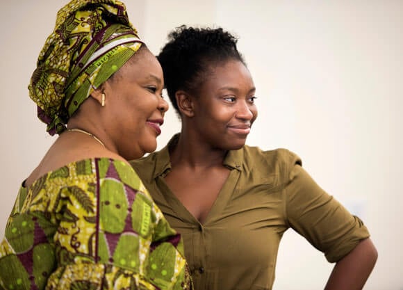 Brionna Miller posing with Nobel Prize laureates Leymah Gbowee