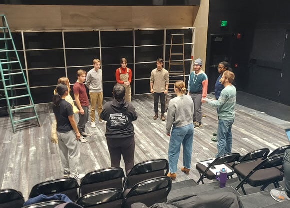 Students gathered in a circle practicing the production 'The Seagull'