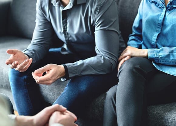 Stock photo of individuals talking to one another