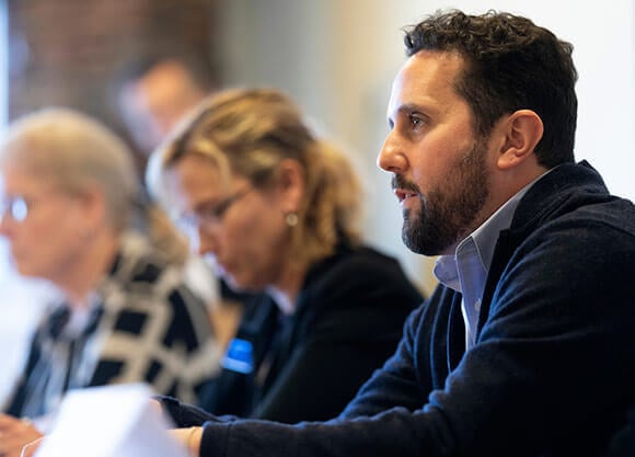 man listening to a speech