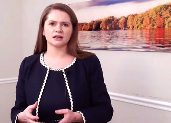 A law student gestures while presenting her case.