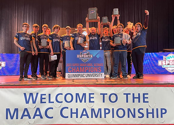 eSports team smiles with their trophy.