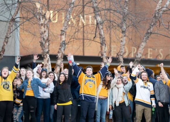 Student cheer  in Quinnipiac gear