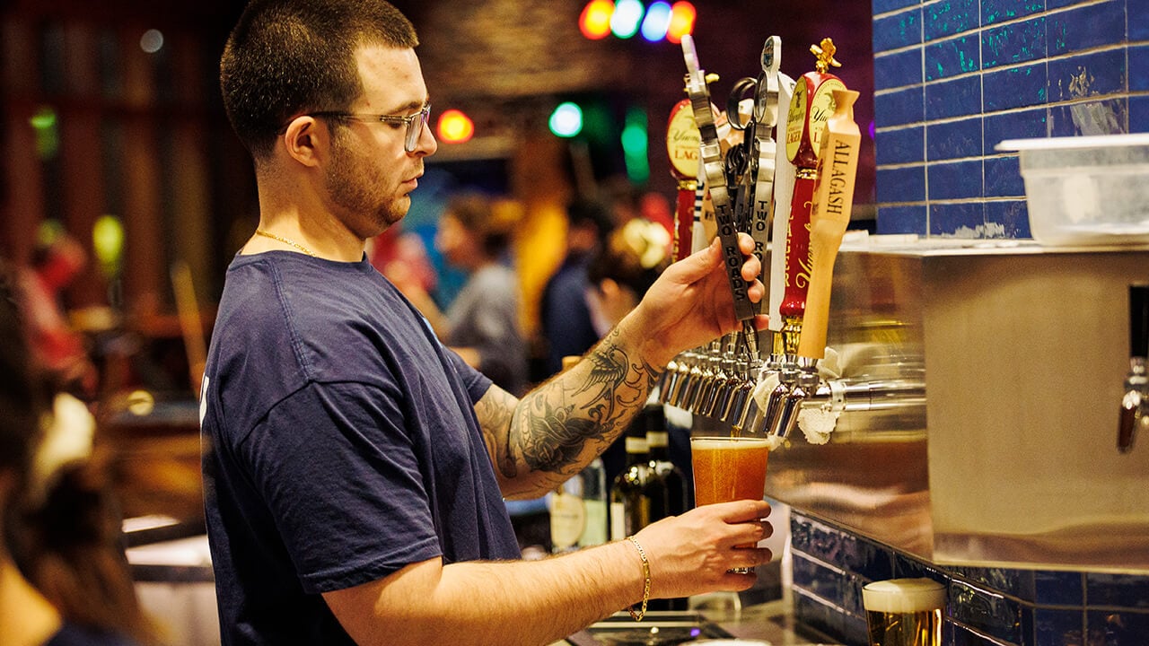 Bartender pouring a drink at on the rocks pub and grill