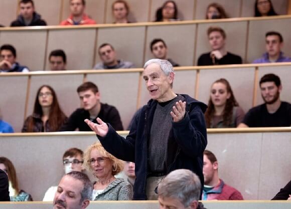 Rothman speaks in a lecture hall.