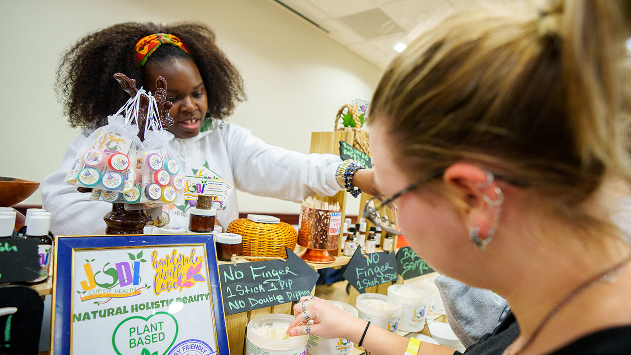 Small business owner showing her products to a customer