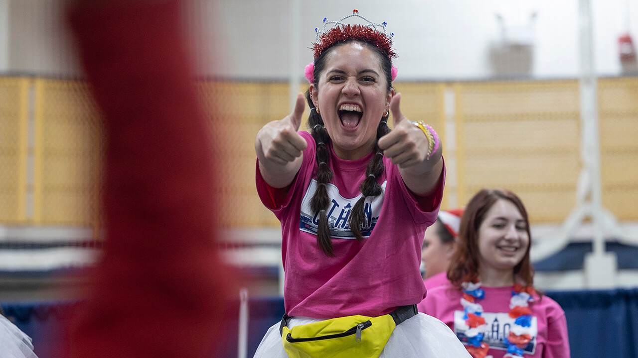 Girl posing enthusiastically with two thumbs up