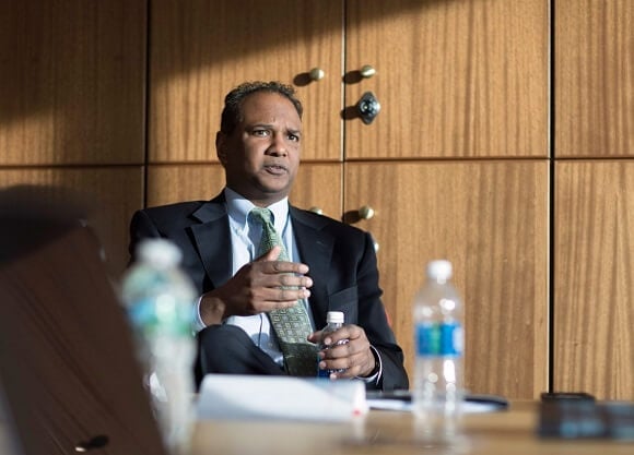 Assistant U.S. Attorney Dave Vatti sits in front of lockers in the School of Law Center