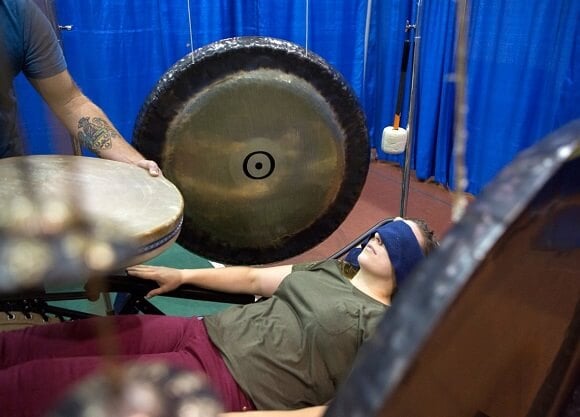 A member of the university community participates in gong therapy.