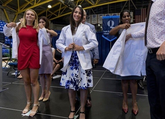 Students put on white coats.