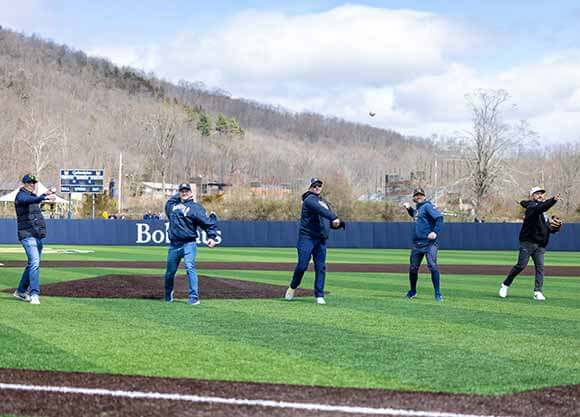 Baseball alumni throw out the first pitch.