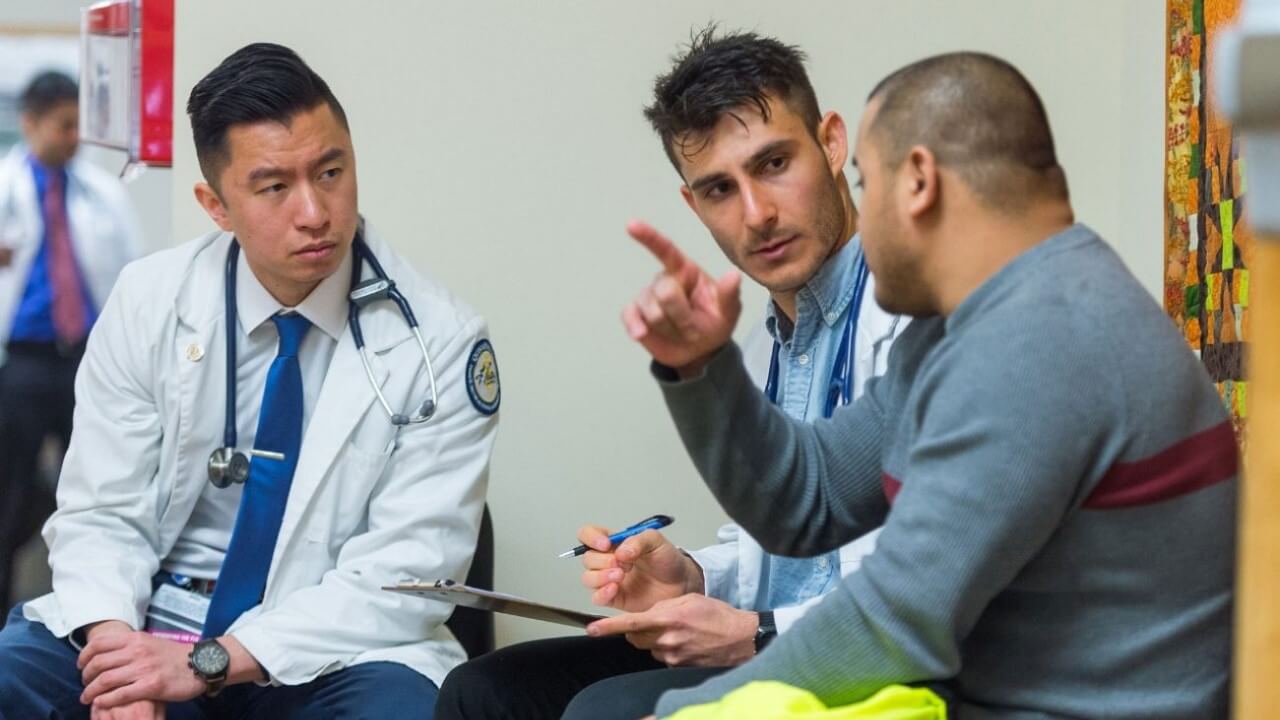 Quinnipiac students with a patient at the Bobcat Community Clinic at Quinnipiac University