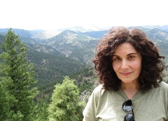 Renée Tursi stands in front of mountains in Montreal, Canada