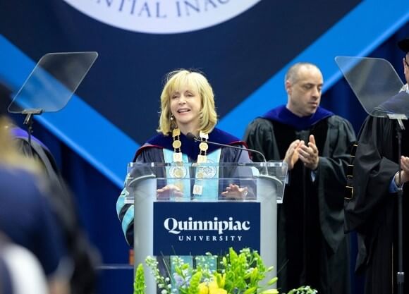 President Olian stands at a podium.