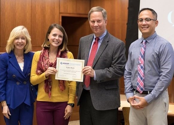 Duch holds a certificate with Olian, Kohlhepp and Bondoc