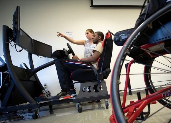 A student learns how to drive a simulated vehicle.