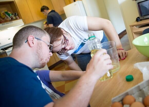 Students measure ingredients on a table.