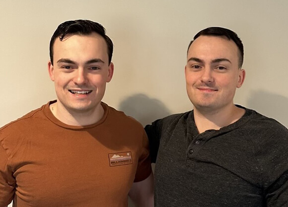 Quinnipiac cybersecurity graduates Kyle DeGennaro and Tyler DeGennaro smile for a photo