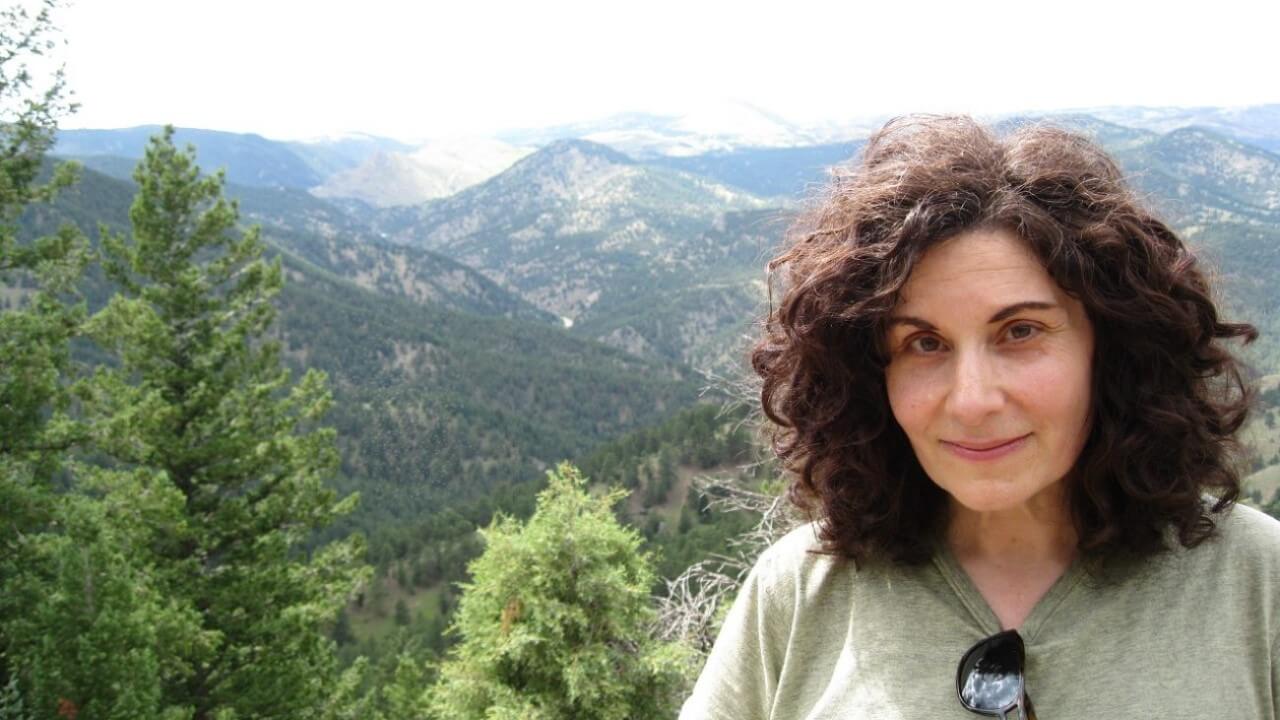 Renée Tursi stands in front of mountains in Montreal, Canada.