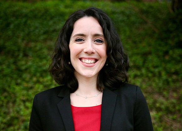 Amanda Klay smiling against some greenery