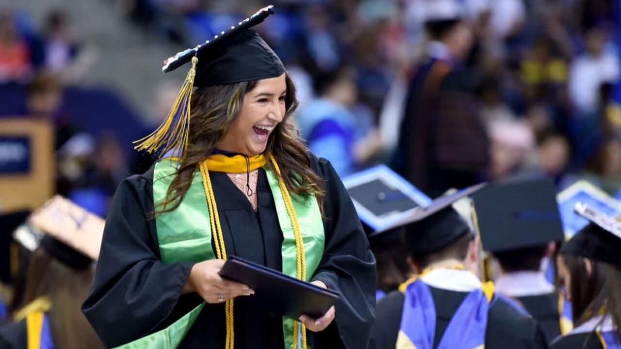 Students from the Class of 2016 celebrate graduation on stage.