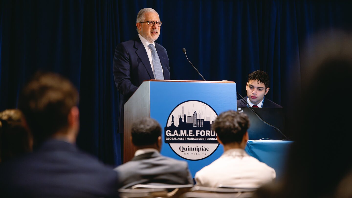 Larry Hamdan speaks at a podium during GAME Forum.