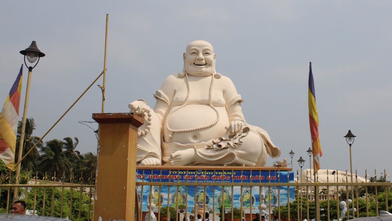 White statue of Buddah smiling