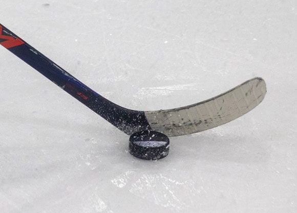 Hockey stick and puck on the ice in the M&T Bank Arena Ice Hockey stadium