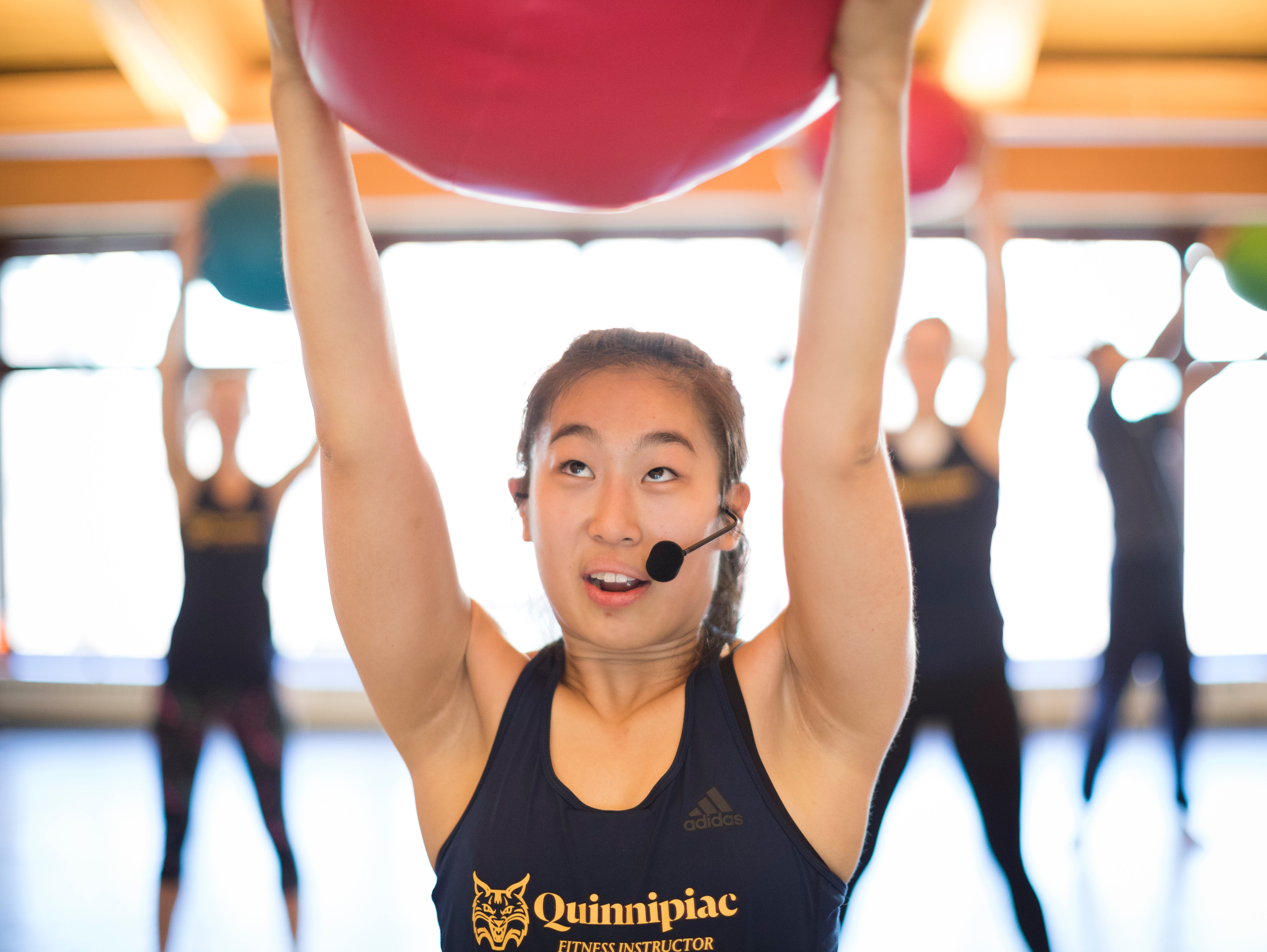 Girl with yoga ball over head