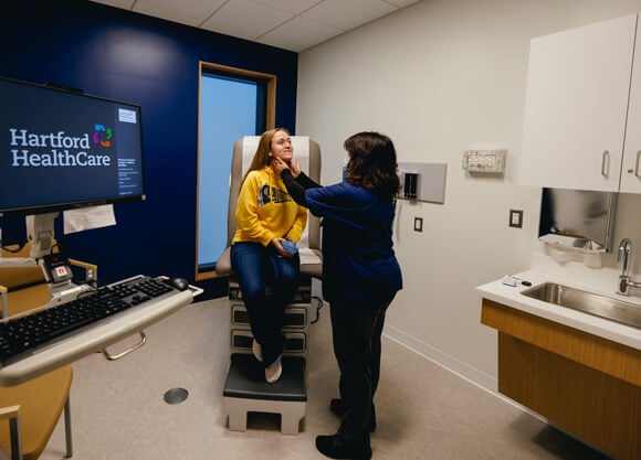 A Quinnipiac student receives a wellness exam from a Hartford HealthCare health services provider