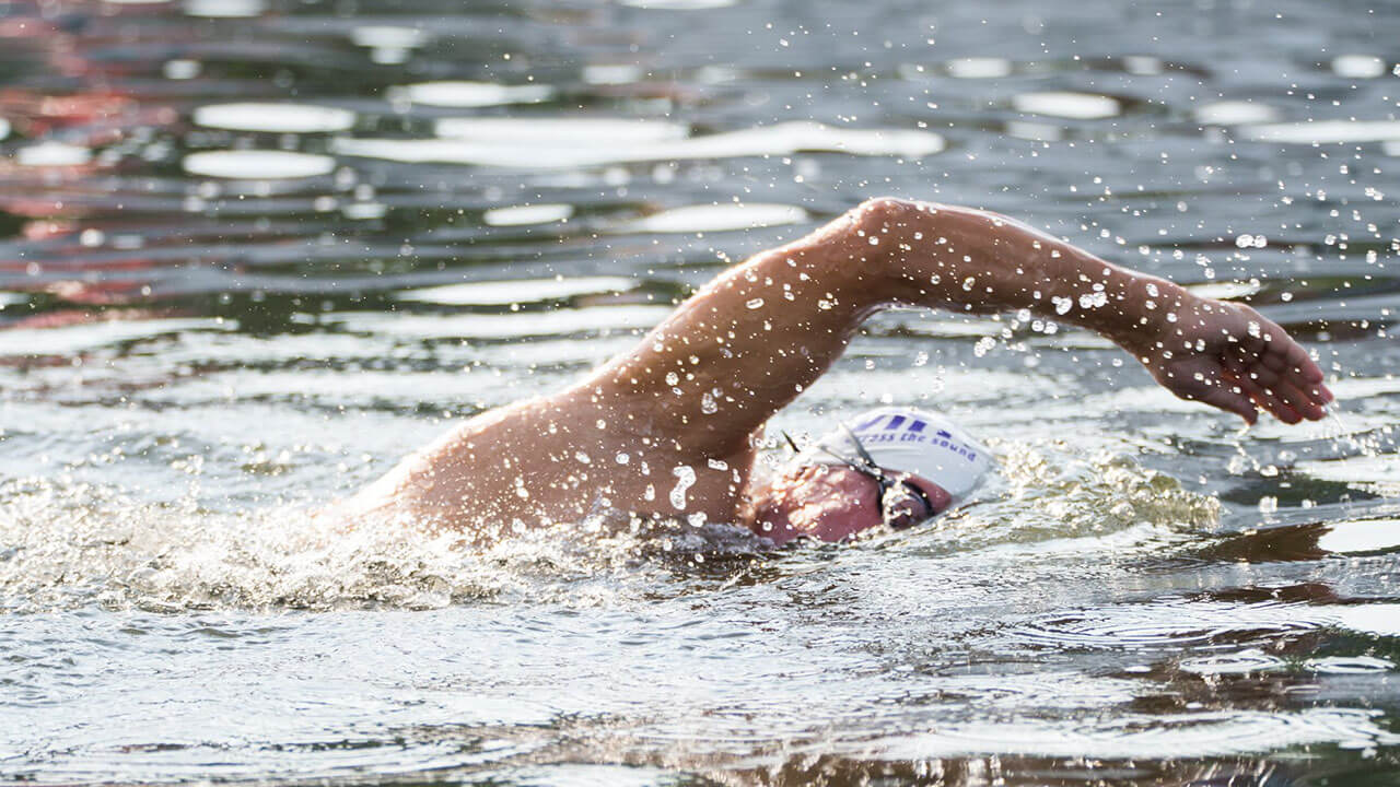 A man swims in a pool.