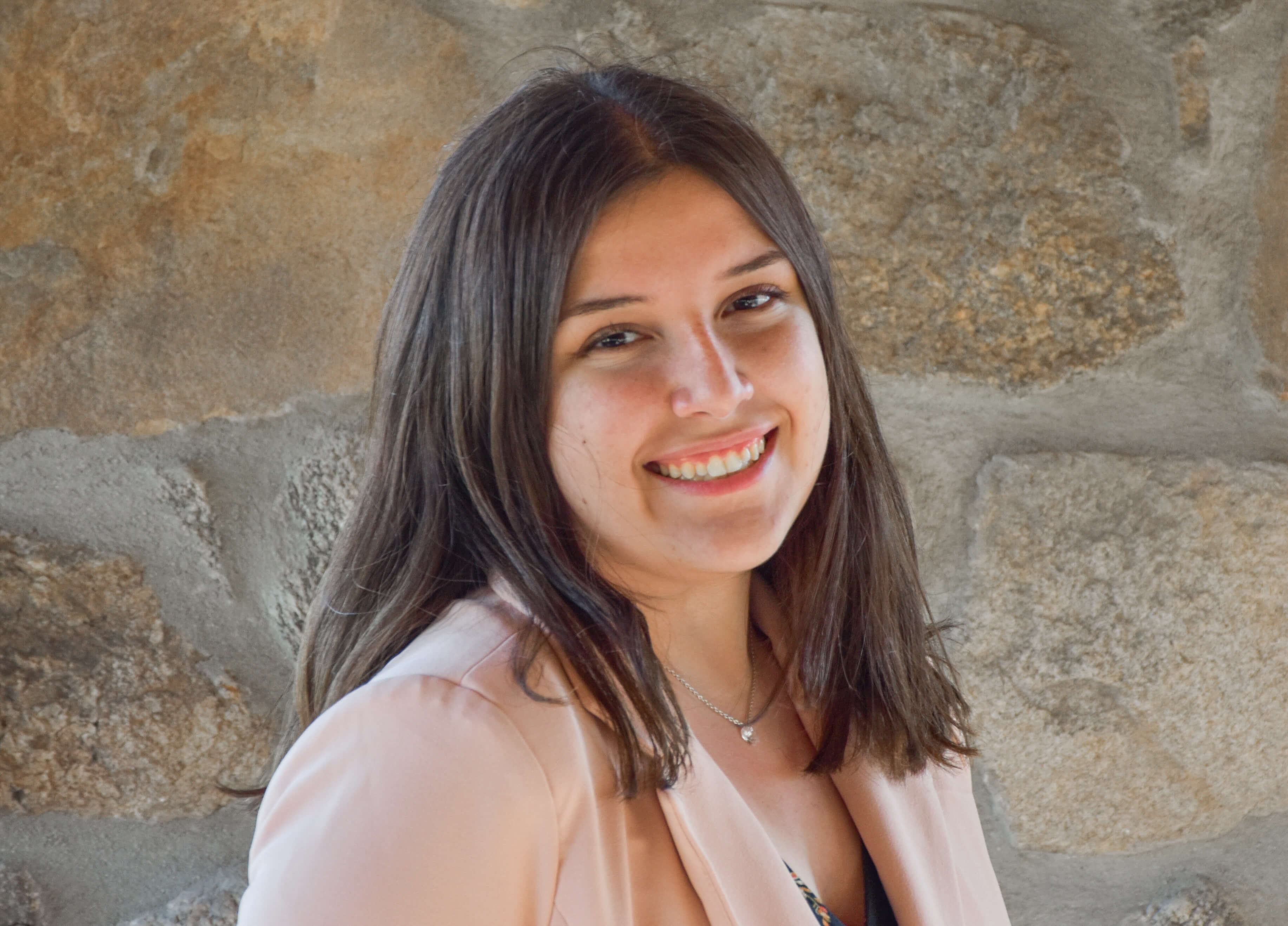 Photo of Jennifer McCue in front of a brick wall