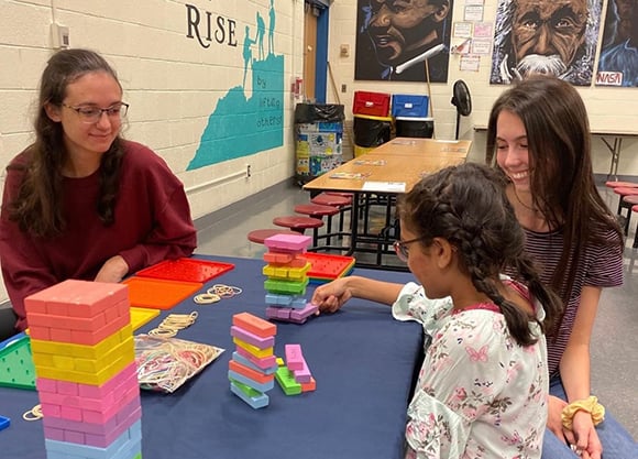 A student-teacher works with a student.