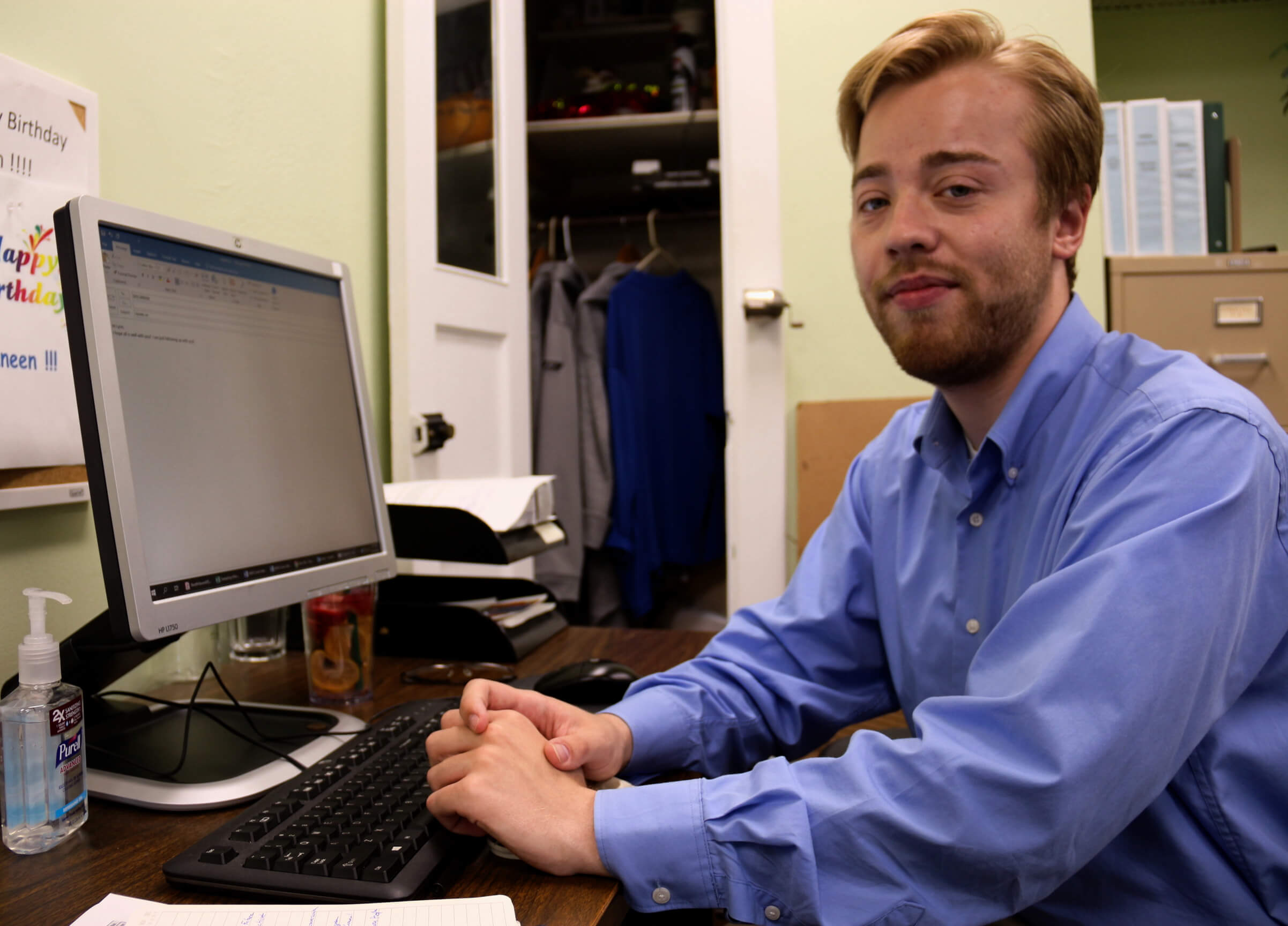 Student fellow sitting at his desk working on projects