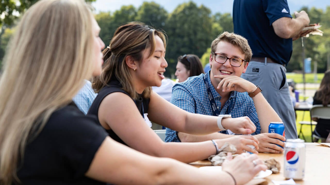 Group of orientation students sitting together and chatting