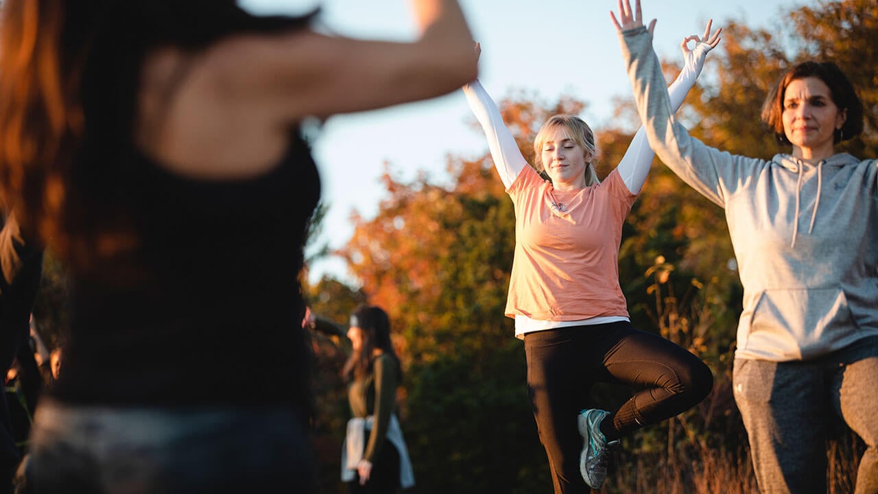 Students take a yoga class at the top of Sleeping Giant