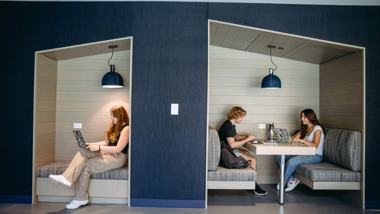 Students sit in booths