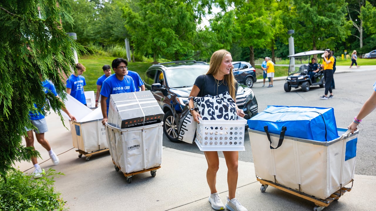 Students pushing laundry carts