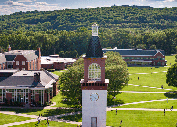 Aerial view of the library clocktower, buildings and the quad with people walking on a sunny day