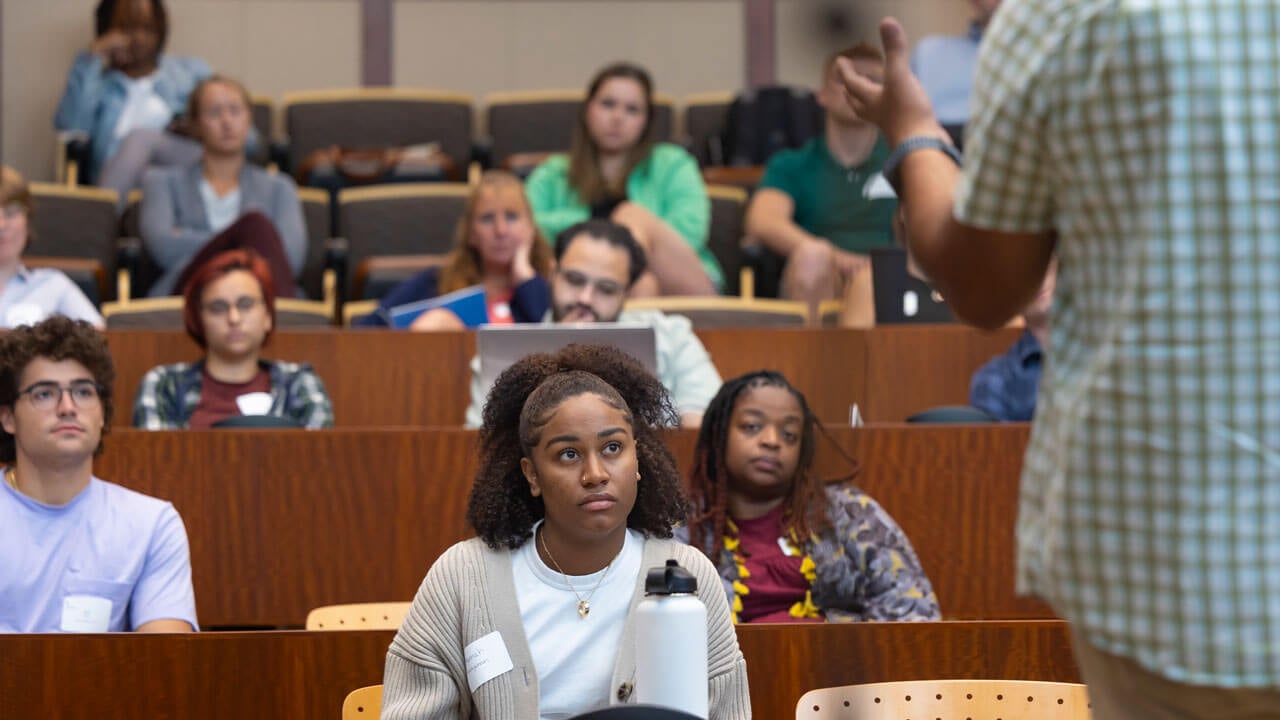 Students listen to a speaker