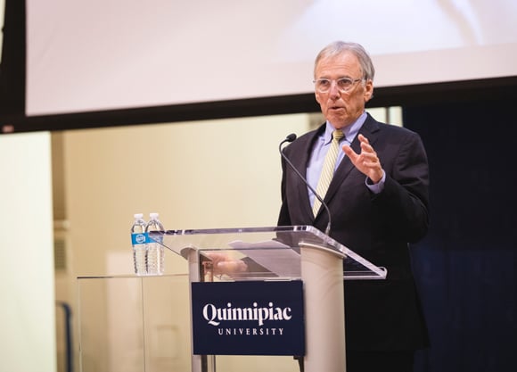 Tim Malloy speaks at a podium