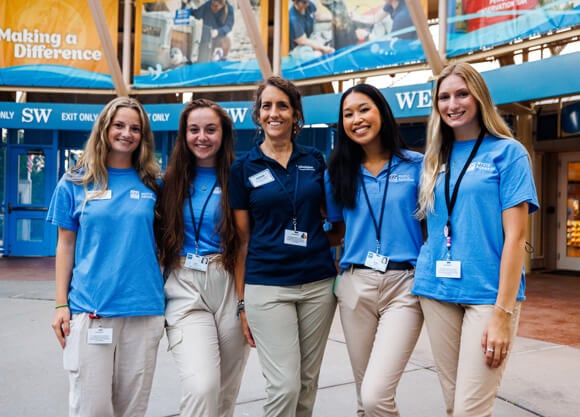 4 female OT students and their female professor posing for a photo