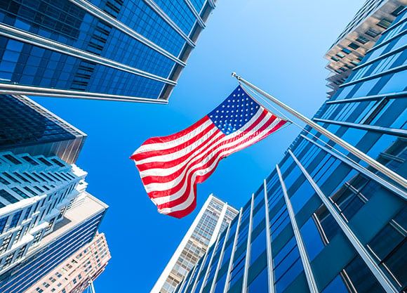 An American flag flies between two buildings.